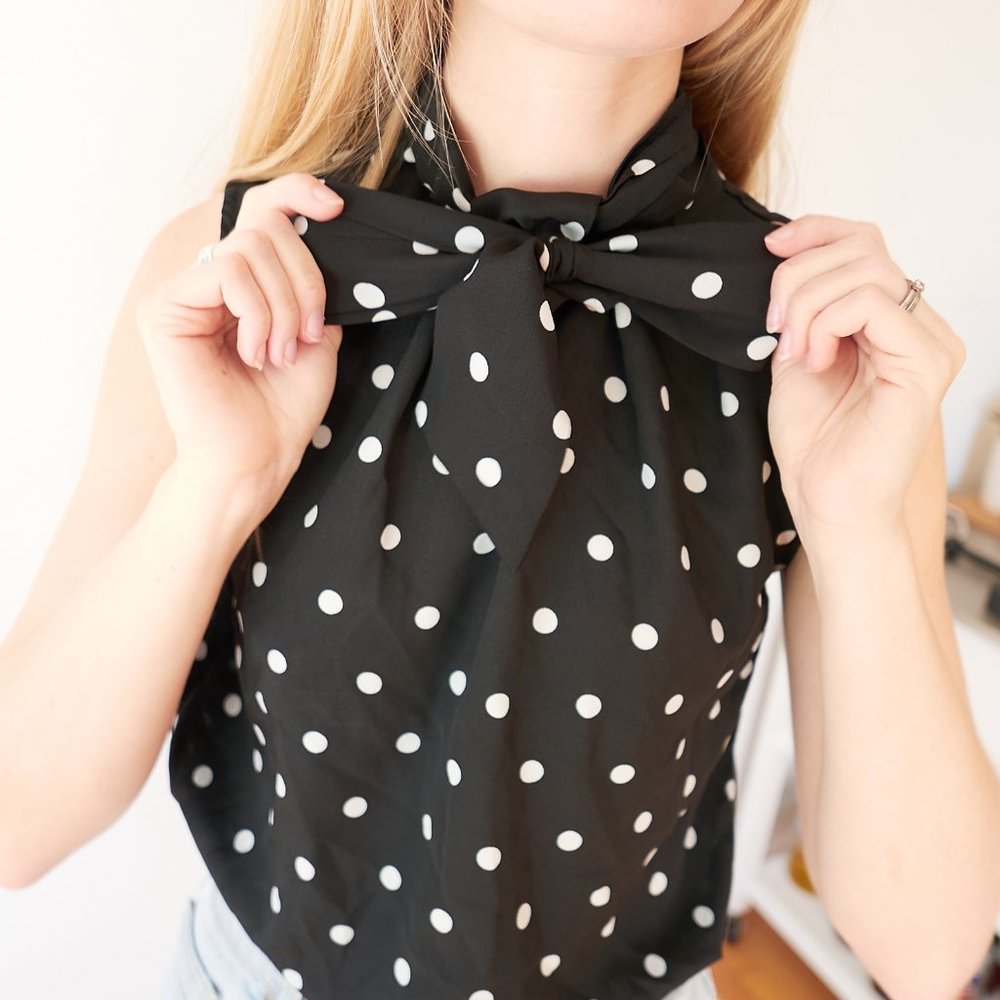 Sleeveless polkadot blouse with tie/bow neckline